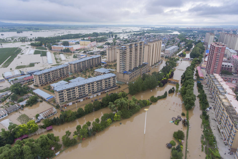 In this aerial photo released by Xinhua News Agency, flood waters cover Yanshou County of Harbin in northeastern China's Heilongjiang Province on Saturday, Aug. 5, 2023. Rain continued to pelt northeastern China in the wake of Typhoon Doksuri as authorities reported more fatalities and missing people while evacuating thousands more. (Gu Jingkun/Xinhua via AP)