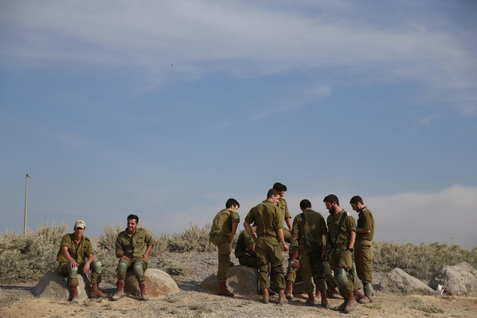 Israeli soldiers wait near Israel and Gaza border, Israel, Friday, Oct. 5, 2018. The Israeli military said Thursday it was bolstering its forces along the Gaza border ahead of another expected explosive Hamas-orchestrated protest. (AP Photo/Ariel Schalit)