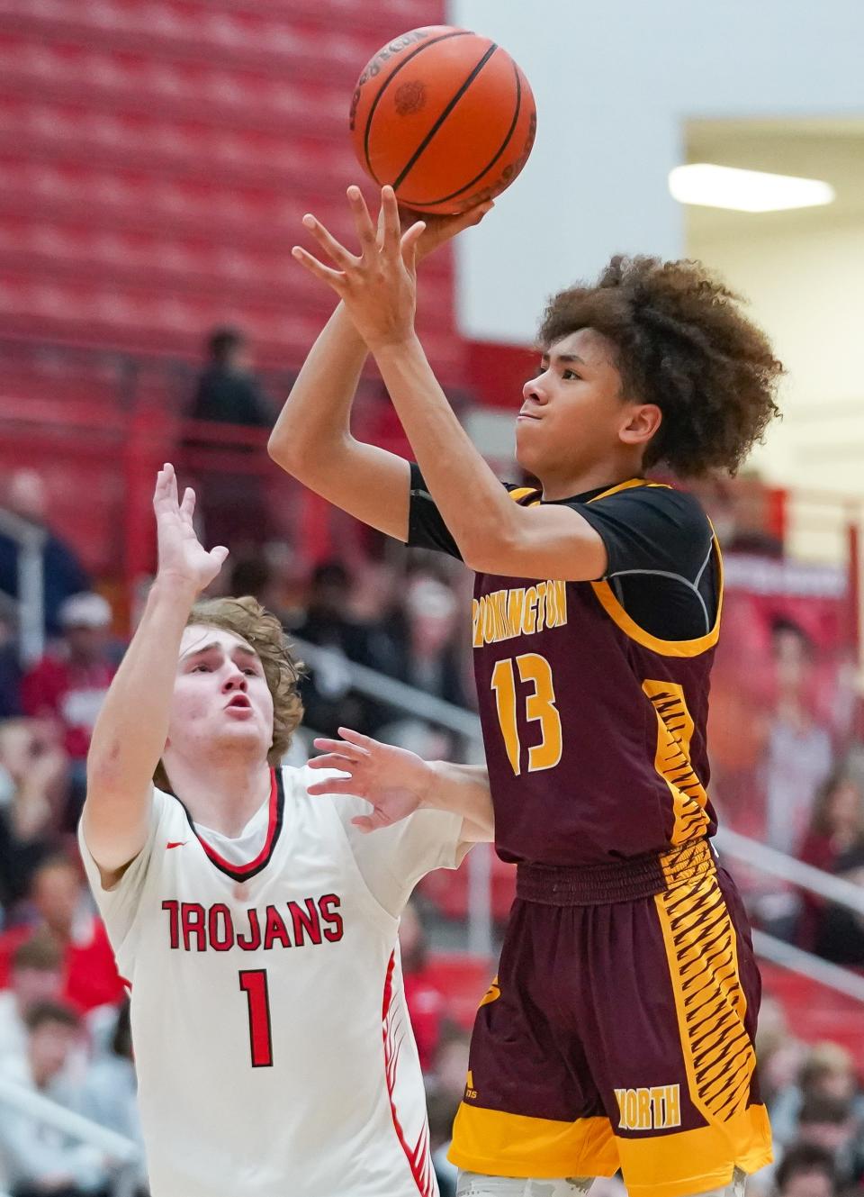 Bloomington North’s Derrick Cross Jr. attempts a shot over Center Grove’s Dylan Meador (1) during their game at Center Grove on Friday, Dec. 1, 2023.