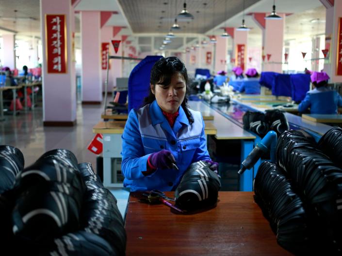 A North Korean woman works at Ryuwon Shoe Factory that specializes in sports footwear, in Pyongyang, North Korea, Friday, Feb. 1, 2019.