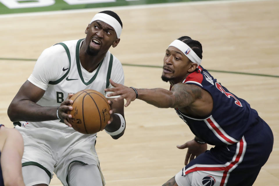 Washington Wizards' Bradley Beal, right, reaches for the ball as Milwaukee Bucks' Bobby Portis drives to the basket during the second half of an NBA basketball game Wednesday, May 5, 2021, in Milwaukee. (AP Photo/Aaron Gash)