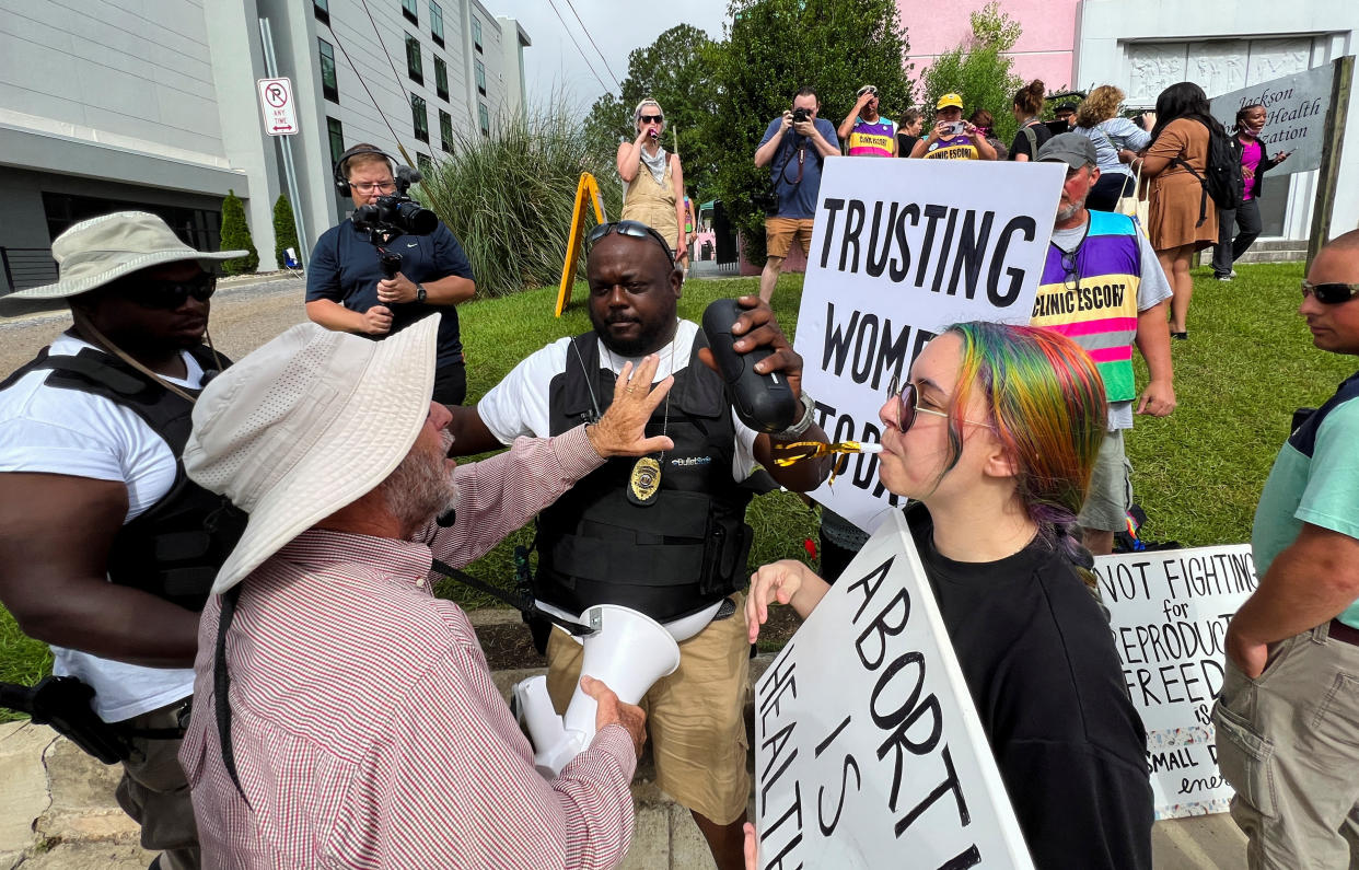 An abortion clinic security guard and abortion rights protesters confront an anti-abortion demonstrator outside the Jackson Women's Health Organization, on the final day when abortions are carried out, before the clinic permanently closes, in Jackson, Miss., on July 6. 