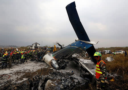 Rescue workers work at the wreckage of a US-Bangla airplane after it crashed at the Tribhuvan International Airport in Kathmandu, Nepal March 12, 2018. REUTERS/ Navesh Chitrakar