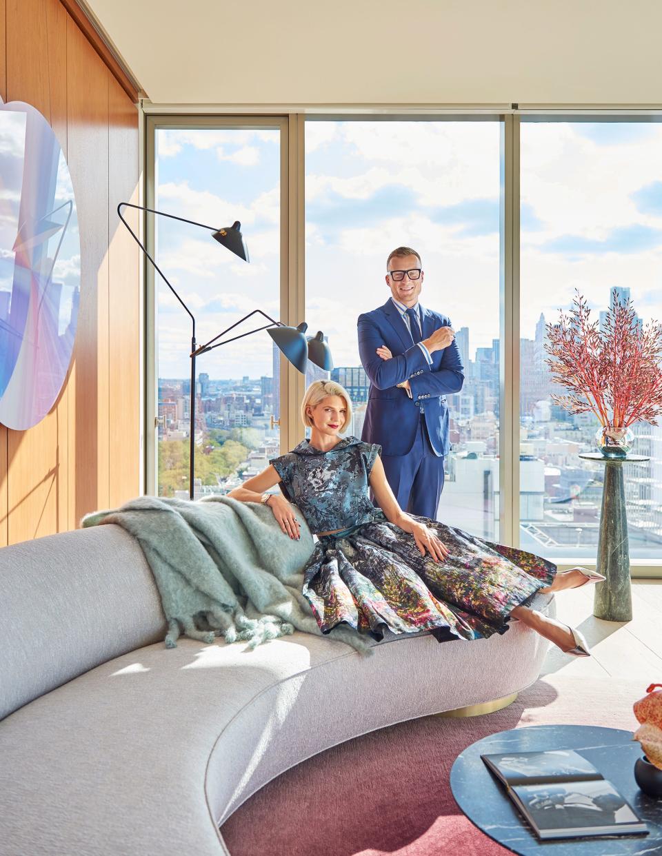 Samantha Angelo, a fashion stylist and designer, and her husband, Peter Ostrega, a legal technology consultant, live in this light-flooded apartment atop Ian Shrager’s Public Hotel on the Lower East Side of Manhattan. The building, which has 11 residential units, was designed by Herzog & de Meuron, with interior architecture by minimalist master John Pawson. The couple, who are frequently photographed at social events wearing glamorous and somewhat retro ensembles, say they’ve had an “incredible journey” since arriving in New York City in 2014. Back then, they lived in a creaky old apartment on Mott Street, where they could see the construction of the high-rise they now call home. “We started fantasizing about living in a space like that but had no way of accomplishing it at the time,” says Ostrega, who emigrated from Poland to the United States as a child, at a time when his country had imposed martial law. Angelo, who played the clarinet with the United States Marine Band for almost a decade, quit her position to start a new career as a stylist and creative director. Armann Ortega of AO Atelier helped the couple with the home’s interior design.