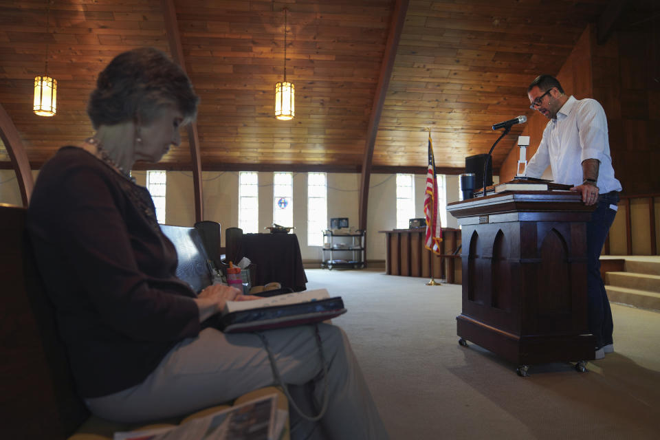 Pastor Ryan Burge, right, an associate professor of political science at Eastern Illinois University and author of "The Nones," a book on the growing number of religiously unaffiliated Americans, preaches a sermon at First Baptist Church in Mt. Vernon, Ill., Sunday, Sept. 10, 2023. For Burge, the rising number of "nones" and the dwindling number of religious is not simply a statistic, but a fact that he's been witnessing in his own parish for the past 16 years. (AP Photo/Jessie Wardarski)