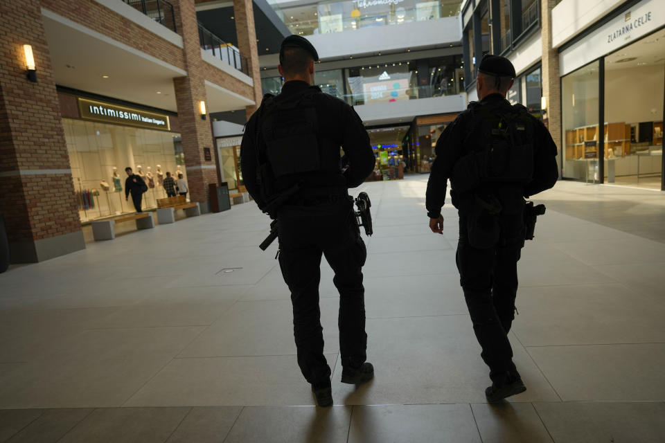 Serbian special police officers patrol at a shopping mall in Belgrade, Serbia, Monday, March 25, 2024. Serbian government increased its security alert posture after the deadly attack at a Russian concert hall. (AP Photo/Darko Vojinovic)