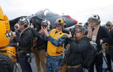 Journalists record activities aboard the USS Bonhomme Richard amphibious assault ship off the coast of Sydney, Australia, before a ceremony marking the start of Talisman Saber 2017, a biennial joint military exercise between the United States and Australia June 29, 2017. REUTERS/Jason Reed