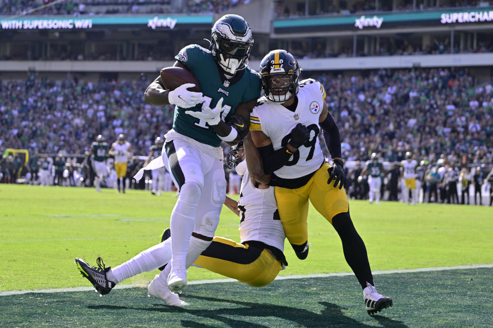 Philadelphia Eagles wide receiver A.J. Brown (11) catches a touchdown pass against Pittsburgh Steelers safety Minkah Fitzpatrick (39) and cornerback Ahkello Witherspoon (25) during the first half of an NFL football game between the Pittsburgh Steelers and Philadelphia Eagles, Sunday, Oct. 30, 2022, in Philadelphia. (AP Photo/Derik Hamilton)