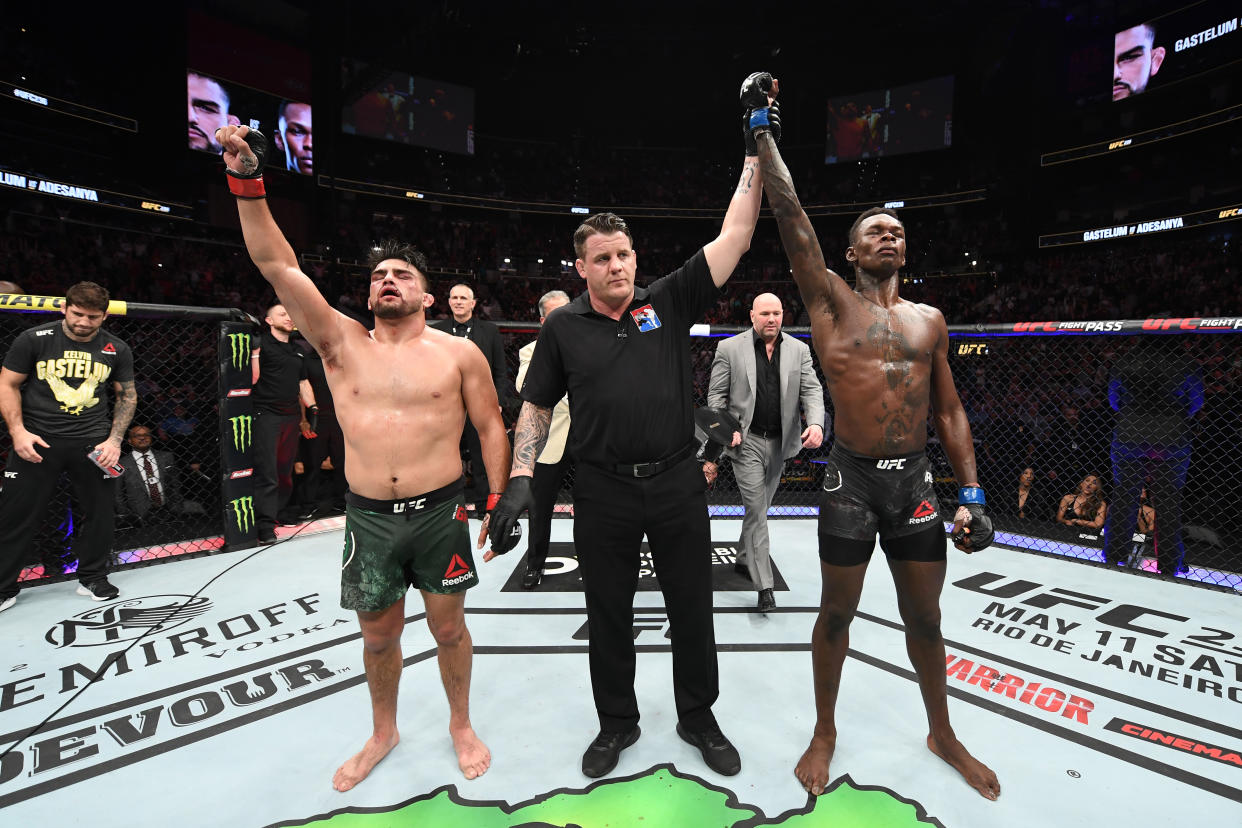 ATLANTA, GA - APRIL 13:  (R-L) Israel Adesanya reacts after defeating Kelvin Gastelum by unanimous decision in their interim middleweight championship bout during the UFC 236 event at State Farm Arena on April 13, 2019 in Atlanta, Georgia. (Photo by Josh Hedges/Zuffa LLC/Zuffa LLC via Getty Images)