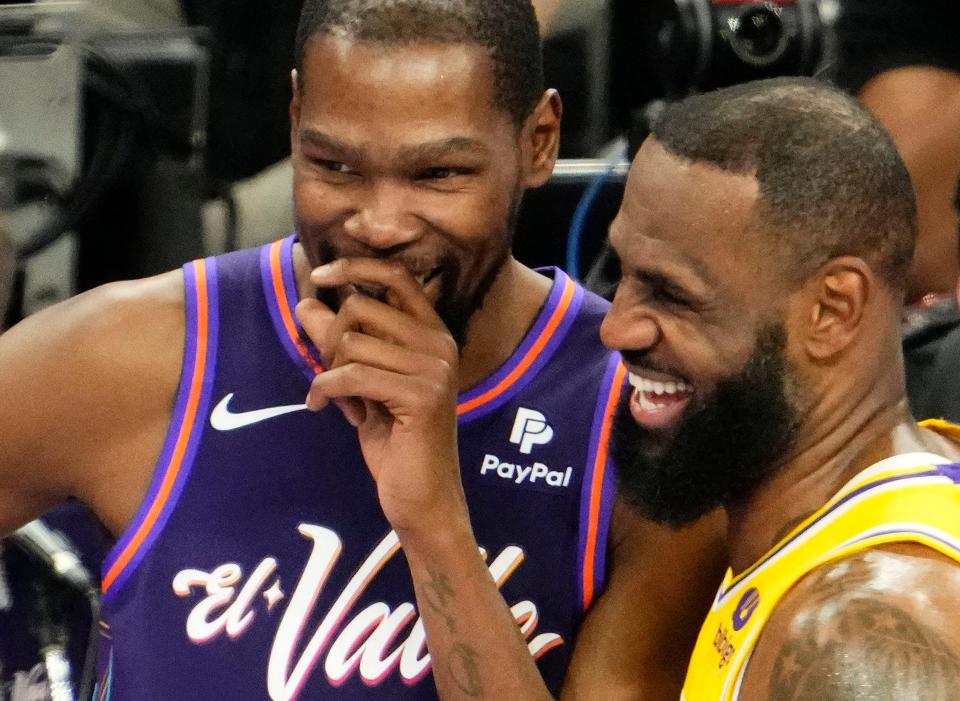 Phoenix Suns forward Kevin Durant (35) cares a laugh with Los Angeles Lakers forward LeBron James (23) in the first half of the in-season tournament game at Footprint Center in Phoenix on Nov. 10, 2023.