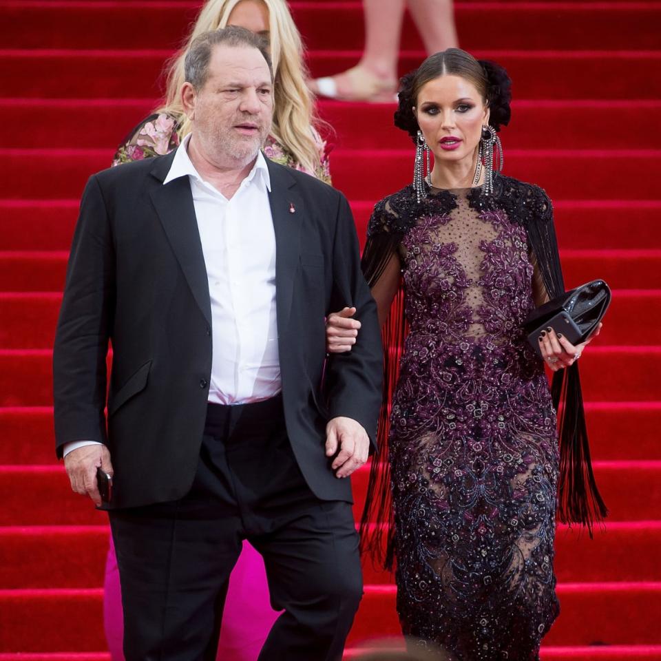 Harvey Weinstein and Georgina Chapman walk down stairs at the 2015 Met Gala