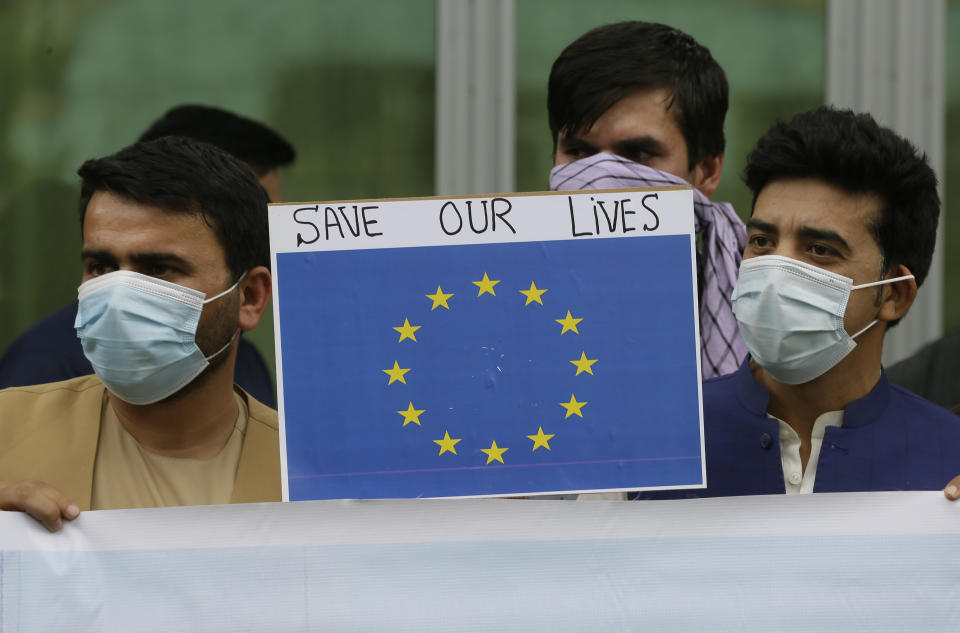 In this Friday, April 30, 2021, photo former Afghan interpreters hold placards during a protest against the U.S. government and NATO in Kabul, Afghanistan. (AP Photo/Mariam Zuhaib)