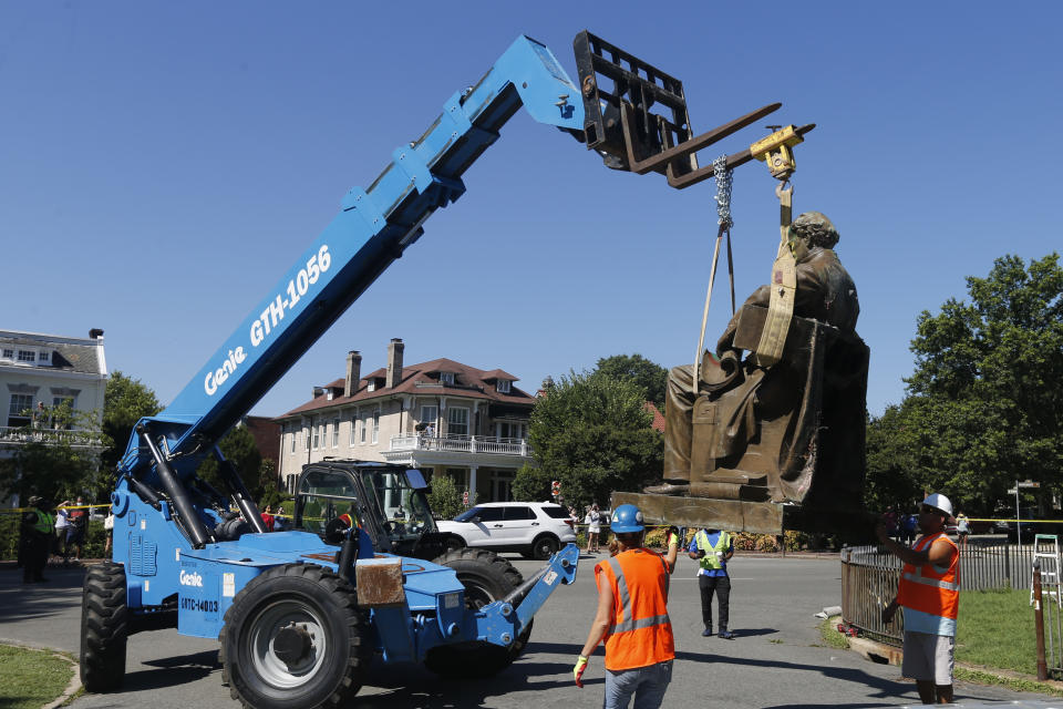 Workers remove the statue of Confederate Naval officer Matthew Fontaine Maury on Monument Avenue, Thursday July 2, 2020, in Richmond, Va. Maury was better known for his work in oceanography and other sciences before the Civil War. His statue is the second removed since a new state law was enacted on July first. (AP Photo/Steve Helber)