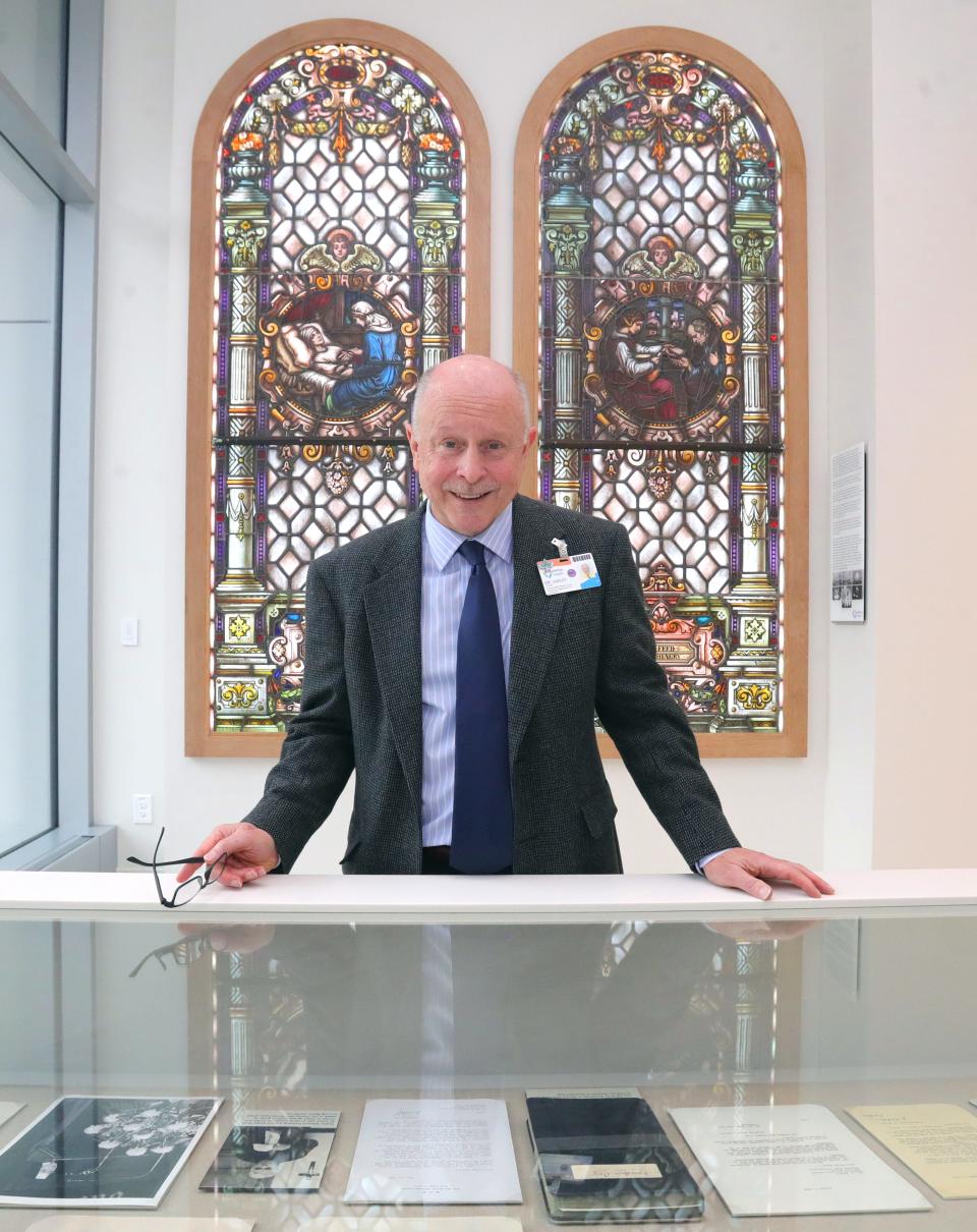 Dr. Joseph Varley, chair of Summa Health Department of Psychiatry, stands in front of stained-glass windows from the former Sister Ignatia Chapel at St. Thomas Hospital that were moved to the new Juve Family Behavioral Health Pavilion.