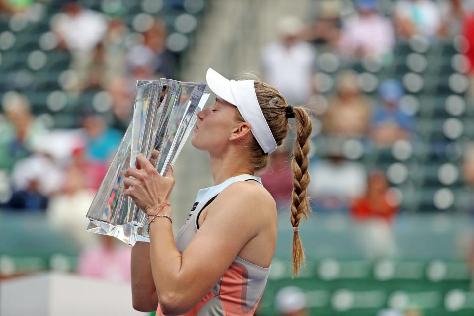 Elena Rybakina of Kazakshstan kisses the trophy after defeating Aryna Sabalenka of Belarus to win the BNP Paribas Open in Indian Wells, Calif., on Sunday, March 19, 2023.