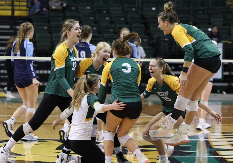 Ursuline players Katie Gielas (12), Lindy Radaszewski (facing camera), Sydney Breissinger (kneeling), Abby Riehle (3), Maddie Pitzer (15)  and Lindsey Green (right), celebrate winning the state tournament Nov. 12, 2022, at Wright State University. Ursuline defeated Magnificat, 3 sets to 1, to earn the state championship.