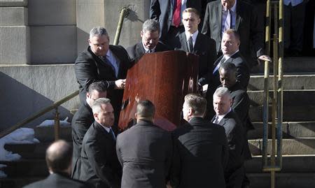 The casket containing the remains of Philip Seymour Hoffman is carried down the steps following his funeral at St. Ignatius church in the Manhattan borough of New York February 7, 2014. REUTERS/Carlo Allegri