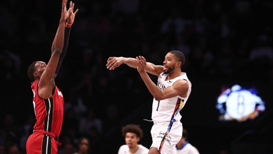 Feb 15, 2023; Brooklyn, New York, USA; Brooklyn Nets forward Mikal Bridges (1) passes the ball as Miami Heat center Bam Adebayo (13) defends during the first quarter at Barclays Center.