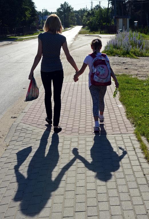 A child and her mother on their way to school on June 14, 2013 in Kuligow, Poland