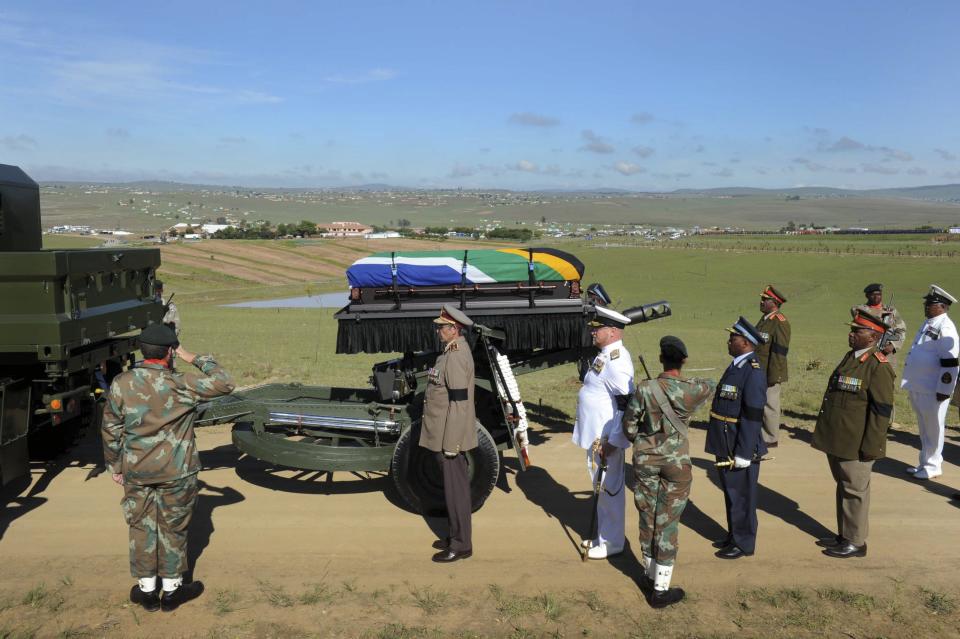 The coffin of former South African President Nelson Mandela arrives on a gun carriage for his funeral ceremony in Qunu, Eastern Cape in this December 15, 2013 handout picture provided by the South African Government Communication and Information System (GCIS). REUTERS/Elmond Jiyane/GCIS/Handout via Reuters (SOUTH AFRICA - Tags: MILITARY SOCIETY OBITUARY POLITICS) THIS IMAGE HAS BEEN SUPPLIED BY A THIRD PARTY. IT IS DISTRIBUTED, EXACTLY AS RECEIVED BY REUTERS, AS A SERVICE TO CLIENTS. FOR EDITORIAL USE ONLY. NOT FOR SALE FOR MARKETING OR ADVERTISING CAMPAIGNS. NO SALES. NO ARCHIVES