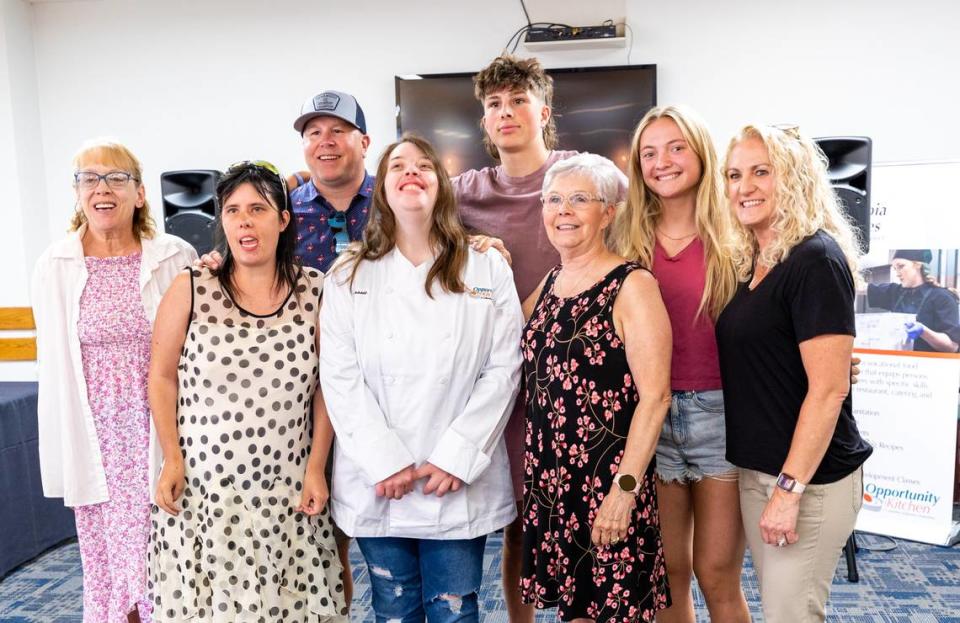 Graduating student, Cassie, is celebrated by her family after the graduation