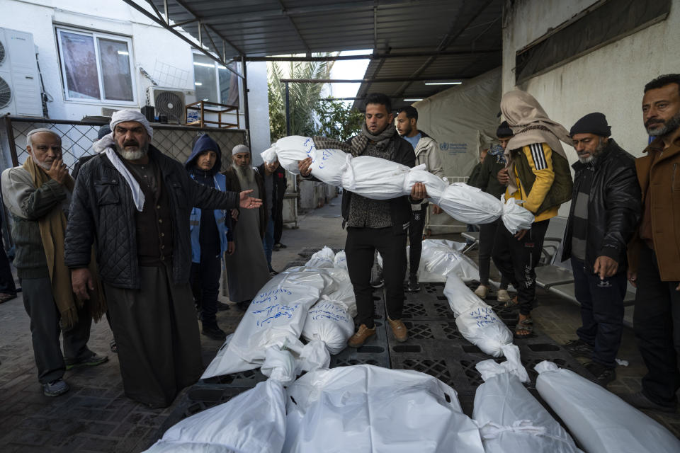 Palestinians mourn their relatives killed in the Israeli bombardment of the Gaza Strip, outside a morgue in Rafah, southern Gaza, Thursday, Jan. 18, 2024. (AP Photo/Fatima Shbair)