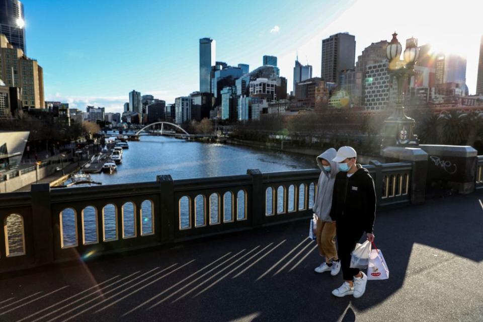 Face mask-clad pedestrians walking through Southbank in Melbourne following a fresh lockdown amid a resurgence in coronavirus cases. 