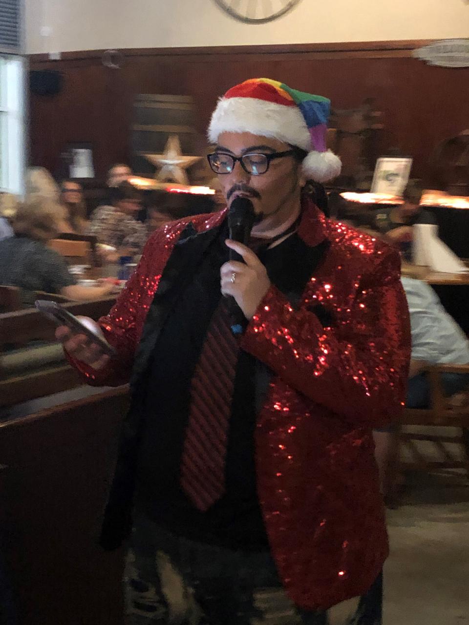 Dominique Sierra calls out the numbers as drag king Nick D’Cuple for a Christmastime drag-queen bingo event at North Fort Myers' Victory Lane Cafe in 2019.