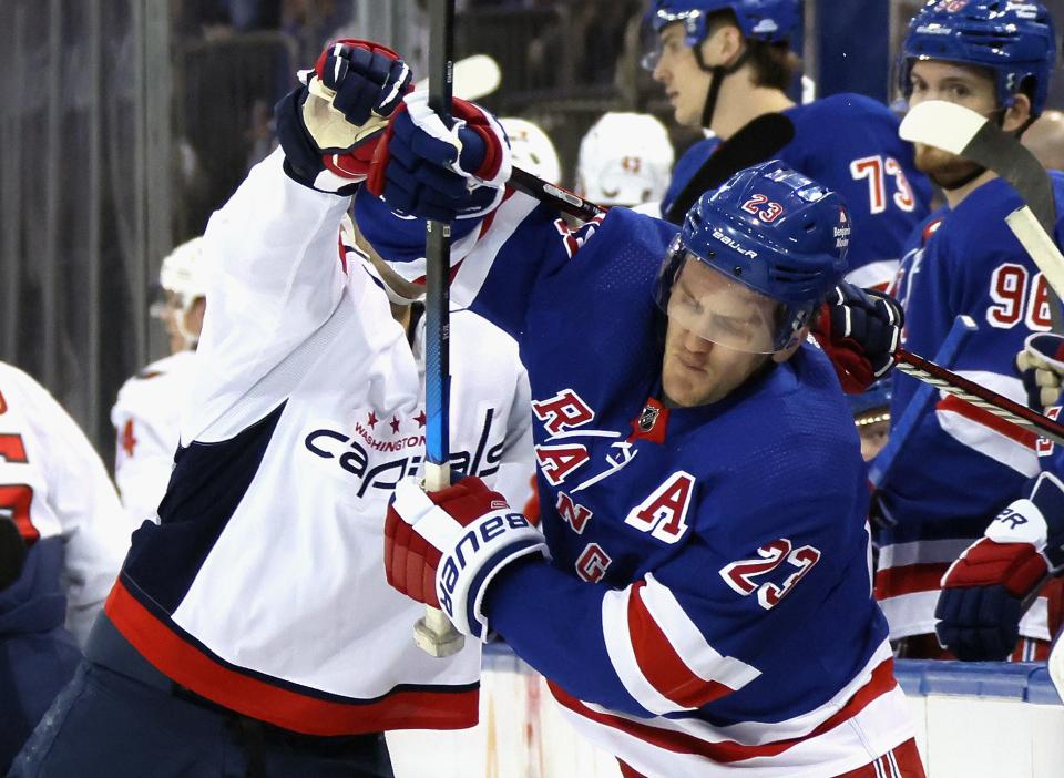 NEW YORK, NEW YORK - APRIL 21: Max Pacioretty #67 of the Washington Capitals is called for crosschecking Adam Fox #23 of the New York Rangers during the first period in Game One of the First Round of the 2024 Stanley Cup Playoffs at Madison Square Garden on April 21, 2024 in New York City.