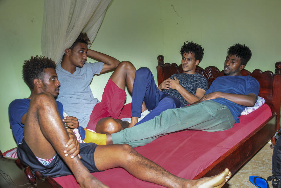 In this photo taken Thursday, Oct. 10, 2019, from left, Eritrean under-20 soccer players Mewael Tesfai Yosief, Simon Asmelash Mekonen, Hanibal Girmay Tekle and Hermon Fessehaye Yohannes talk together in a house where they are staying in Uganda. Four young players with Eritrea's national under-20 soccer team have defected during a tournament in Uganda, the latest players to leave one of the world's most tightly controlled regimes. (AP Photo)