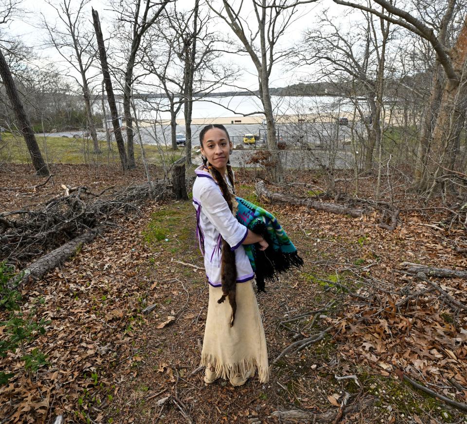 Madas Strickland, a Mashpee Wampanoag Tribe member, is the granddaughter of Earl Mills Sr., who operated The Flume restaurant in Mashpee for 32 years, until 2004. In 2017, Naukabout Brewing Company opened on the property. Strickland stands on Friday near the property with Mashpee Wakeby Pond on the background.