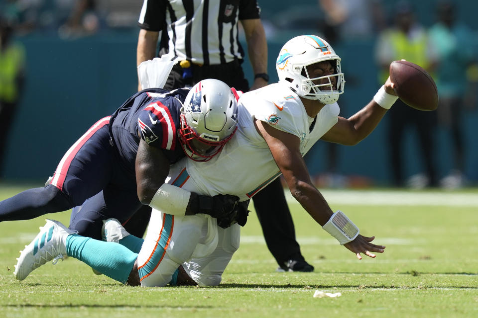 New England Patriots linebacker Mack Wilson Sr. sacks Miami Dolphins quarterback Tua Tagovailoa (1) during the second half of an NFL football game, Sunday, Sept. 11, 2022, in Miami Gardens, Fla. (AP Photo/Rebecca Blackwell)