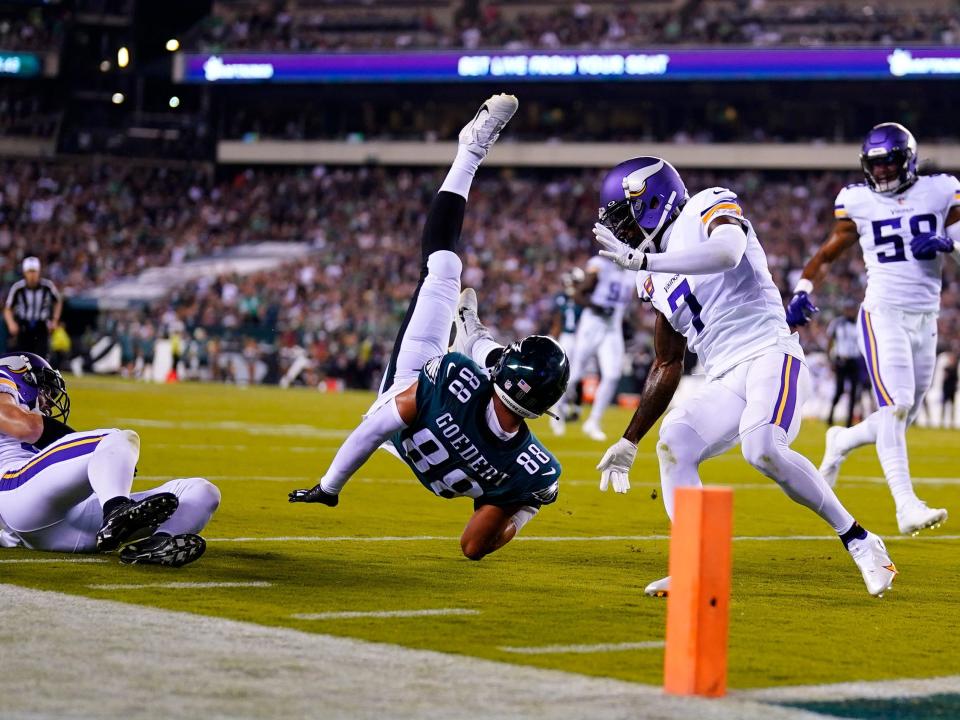 Dallas Goedert is tackled by the Minnesota Vikings.