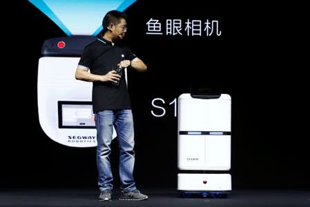 Ninebot President Wang Ye unveils delivery robot Segway DeliveryBot S2 at a Segway-Ninebot product launch event in Beijing