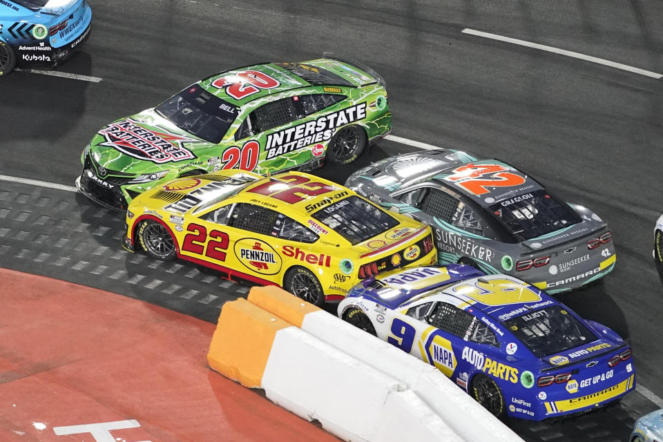 NASCAR Cup Series driver Christopher Bell (20) spins out in front of Joey Logano (22), Noah Gragson (42) and Chase Elliott (9) during the Busch Light Clash NASCAR exhibition auto race at Los Angeles Memorial Coliseum Sunday, Feb. 5, 2023, in Los Angeles. (AP Photo/Mark J. Terrill)