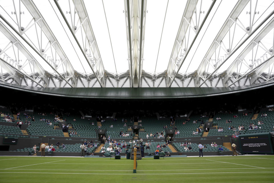 A retractable roof covers Court 1 during a rainfall on day one of the Wimbledon tennis championships in London, Monday, June 27, 2022. (AP Photo/Alberto Pezzali)