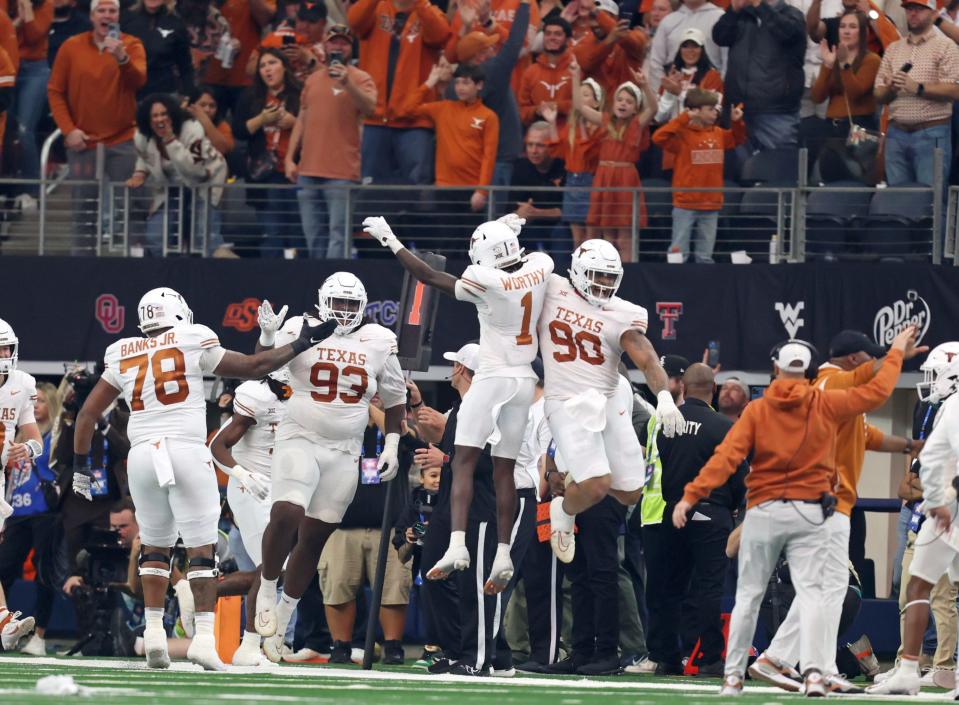 Texas defensive tackle T'Vondre Sweat celebrates his first career touchdown during Saturday's Big 12 title game between Texas and Oklahoma State.