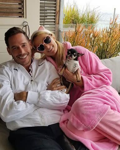 <p>paris hilton/instagram</p> Carter Reum and Paris Hilton snuggle with one of their dogs