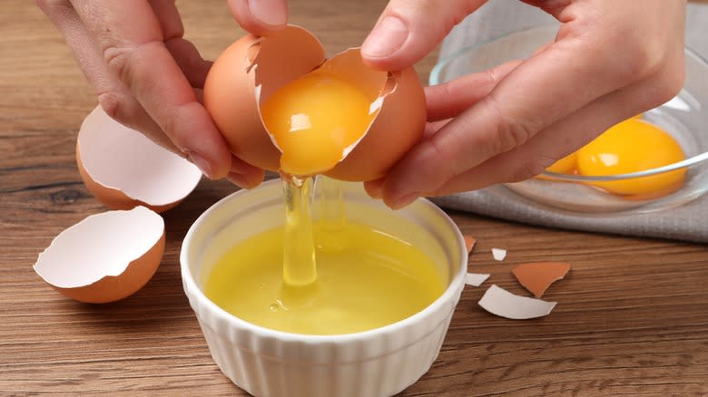 Hands separating eggs 