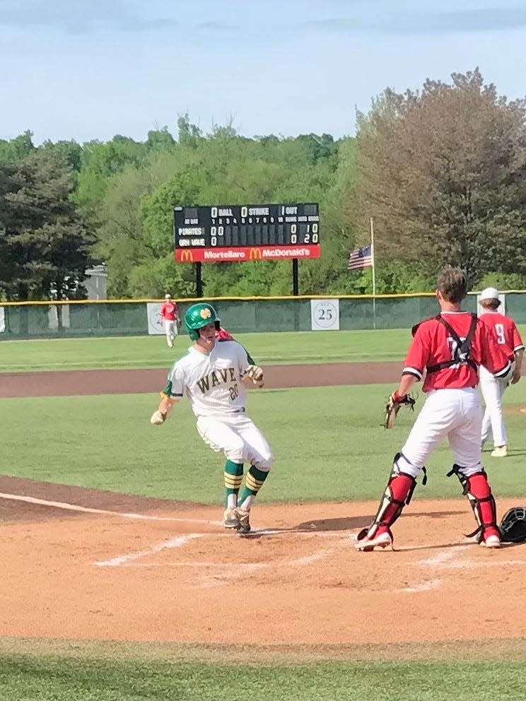 Newark Catholic's Nate Ferrell scores against Cardington during Wednesday's Division IV baseball district championship game at Mount Vernon Nazarene University.