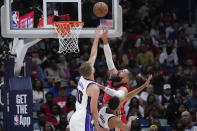 New Orleans Pelicans center Jonas Valanciunas shoots against Sacramento Kings forward Domantas Sabonis (10) in the first half of an NBA basketball play-in tournament game in New Orleans, Friday, April 19, 2024. (AP Photo/Gerald Herbert)