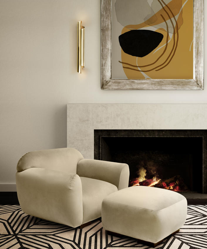 <p> Create a warm and peaceful corner by placing your living room wall lighting ideas near a modern fireplace. This contemporary space with spicy mustard yellow abstract art, a concrete mantel and suede armchair and Ottoman combo and geometric Columbian-inspired CAUCA tencel rug design is an idyllic example of textures and tones. </p> <p> The CYRUS living room wall lighting idea by Brabbu is made of gold plated brass and casts a soft golden glow both up to the ceiling and down to the floor. </p>