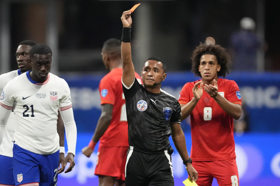 Referee Ivan Barton sends off Tim Weah of the United States, left, during a Copa America Group C soccer match against Panama in Atlanta, Thursday, June 27, 2024. (AP Photo/Mike Stewart)
