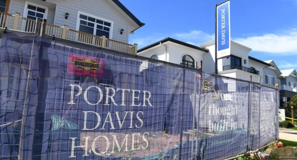 A Porter Davis property can be seen with a fence around its perimeter, looking almost completed and ready for use.