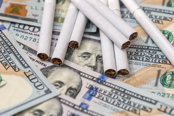 Cigarettes on top of $100 bills