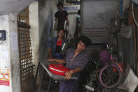 State railway employees carry their belongings after being evicted from their home Saturday, March 20, 2021, in Mandalay, Myanmar. State railway workers in Mandalay have been threatened with eviction to force them to end their support for the Civil Disobedience Movement (CDM) against military rule. (AP Photo)