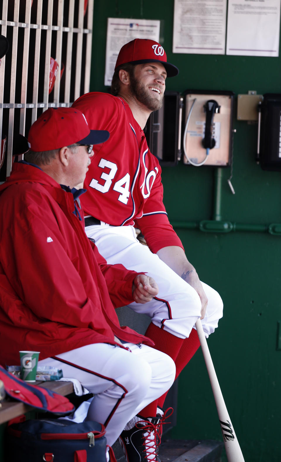 Washington Nationals left fielder Bryce Harper (34) sits on the bench during a baseball game against the Atlanta Braves at Nationals Park, Sunday, April 6, 2014, in Washington. Harper was not in the starting lineup. (AP Photo/Alex Brandon)