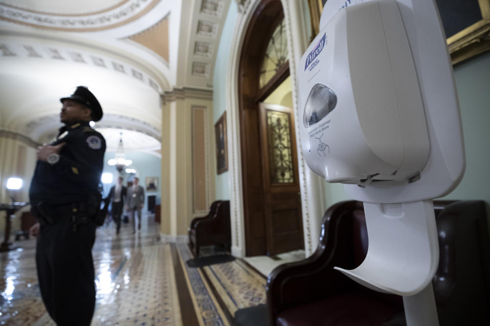 FILE - In this March 3, 2020, file photo a hand sanitizer dispenser is placed just outside the floor of the U.S. Senate chamber after concerns about the coronavirus in Washington. The Senate is set to resume Monday, May 4. (AP Photo/Alex Brandon, File)