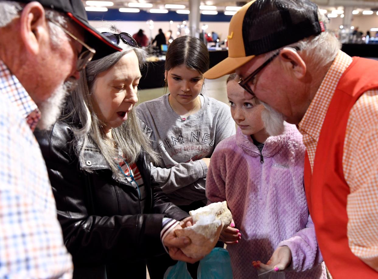 Markay Short reacts as she looks inside her just-cracked geode for the first time during Saturday’s Gem, Mineral & Jewelry Show. With her are her granddaughters Adalyn Galovich, 13 (center) and Emery, 11.