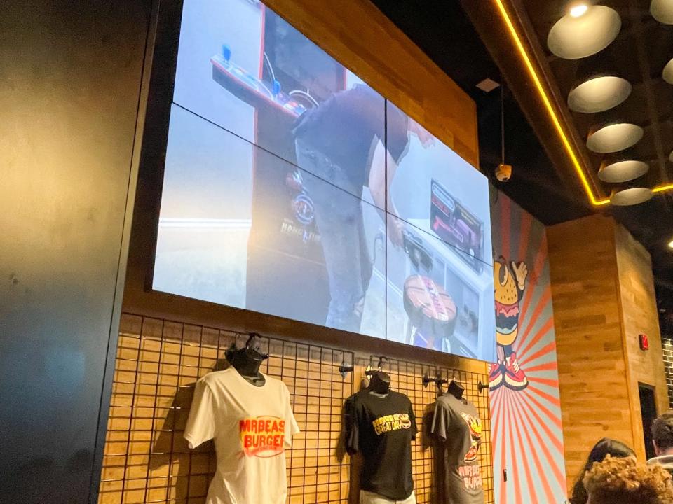 The MrBeast Burger on tshirts under a TV screen